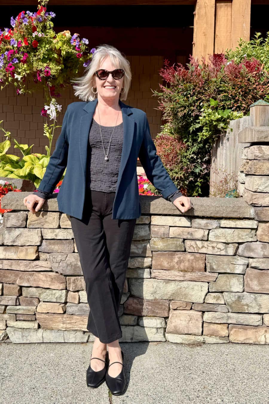 Graphite top with marine blazer, black jeans, and Mary Jane flats for a chic day-to-night outfit over 60
