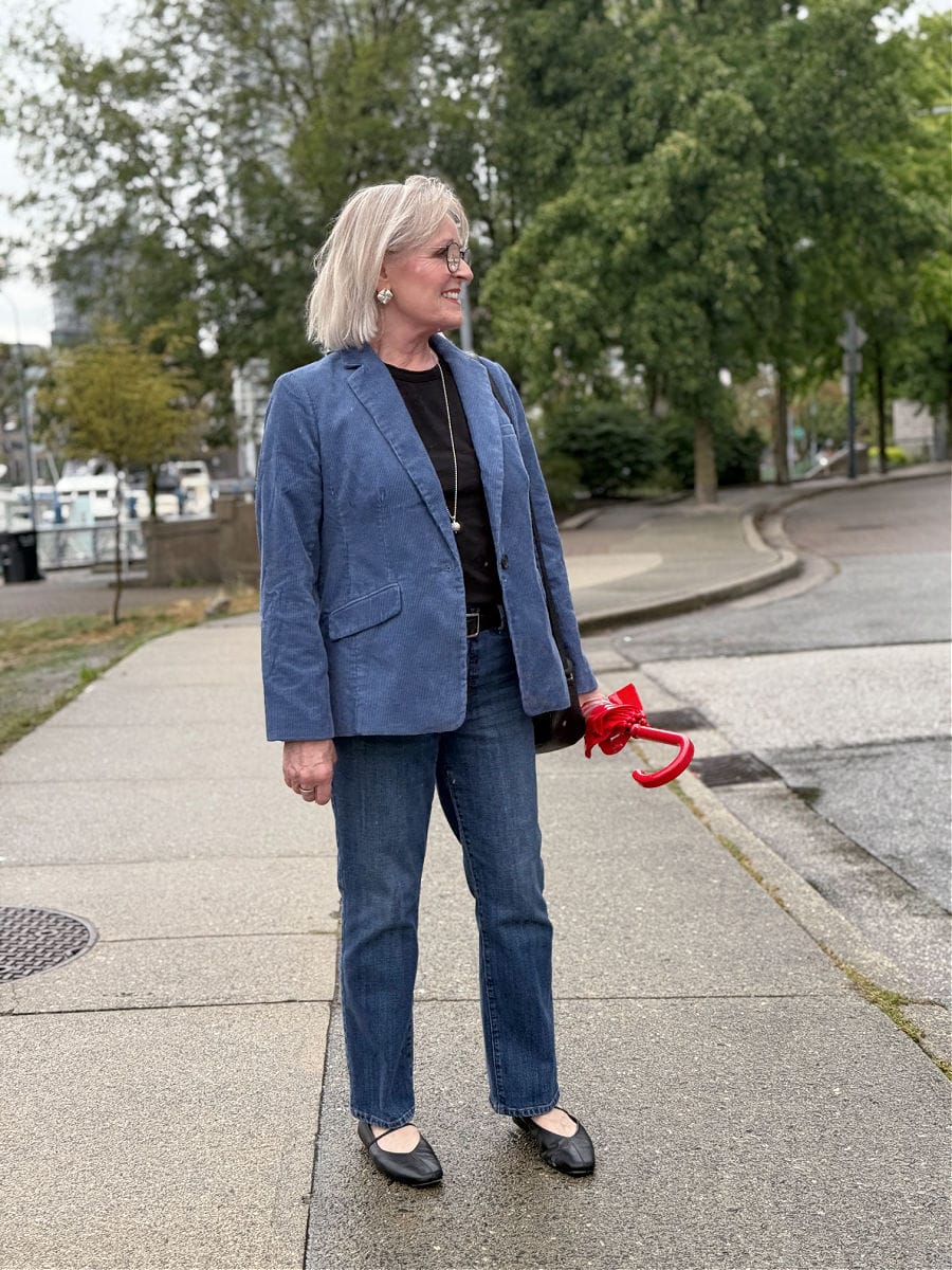 woman over 50 wearing talbots corduroy blazer with barely boot jeans on rainy day