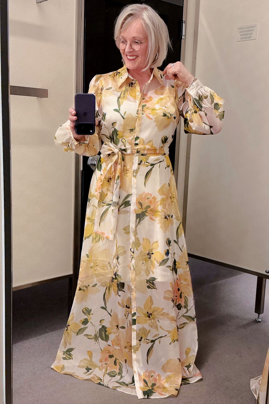 woman over 50 wearing special occasion dress with wide sash for an outdoor spring wedding