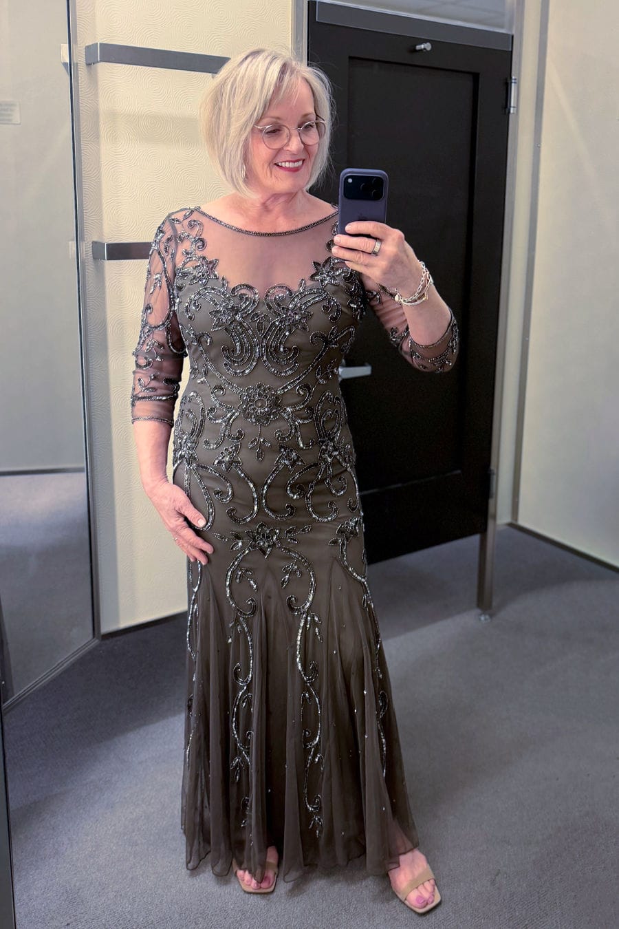 older woman in Pisaro Nights Beaded Illusion Neck Gown
Deep Mocha beaded illusion neck gown with godet flounced hem