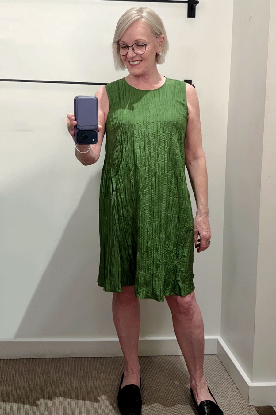 crushed silk green dress on women in eileen fisher dressing room