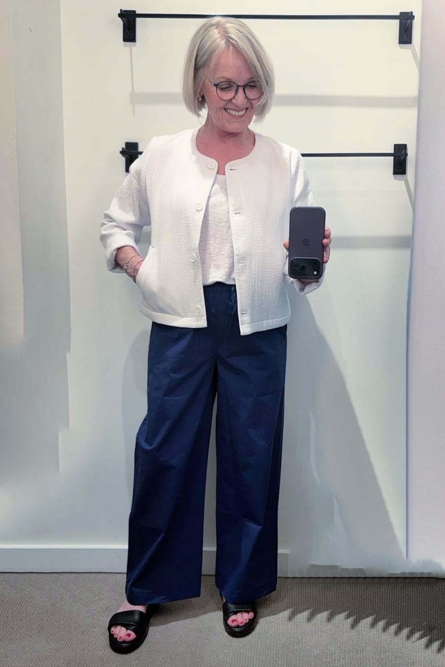 woman over 50 wearing blue cotton poplin wide leg pants and white jacket from eileen fisher