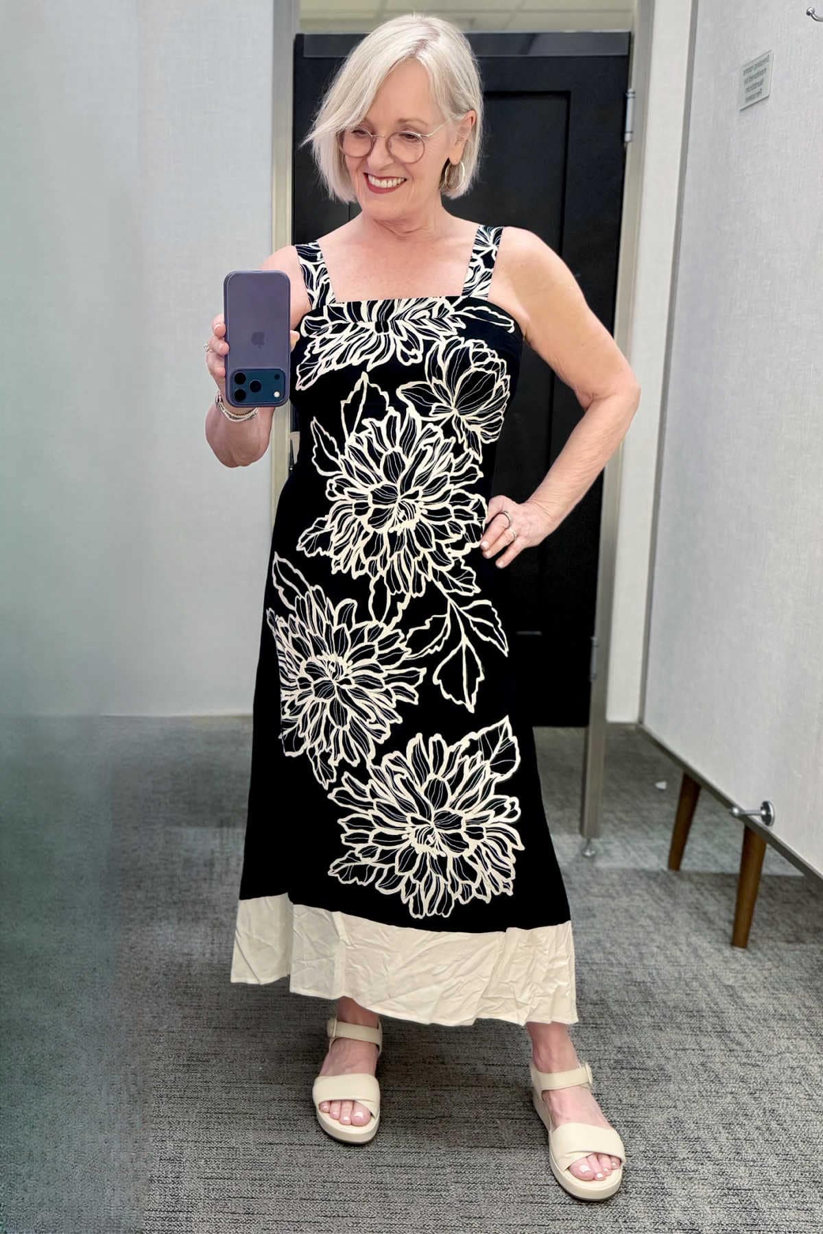 What to wear to a casual summer dinner out featuring a lightweight black and cream floral print midi dress.